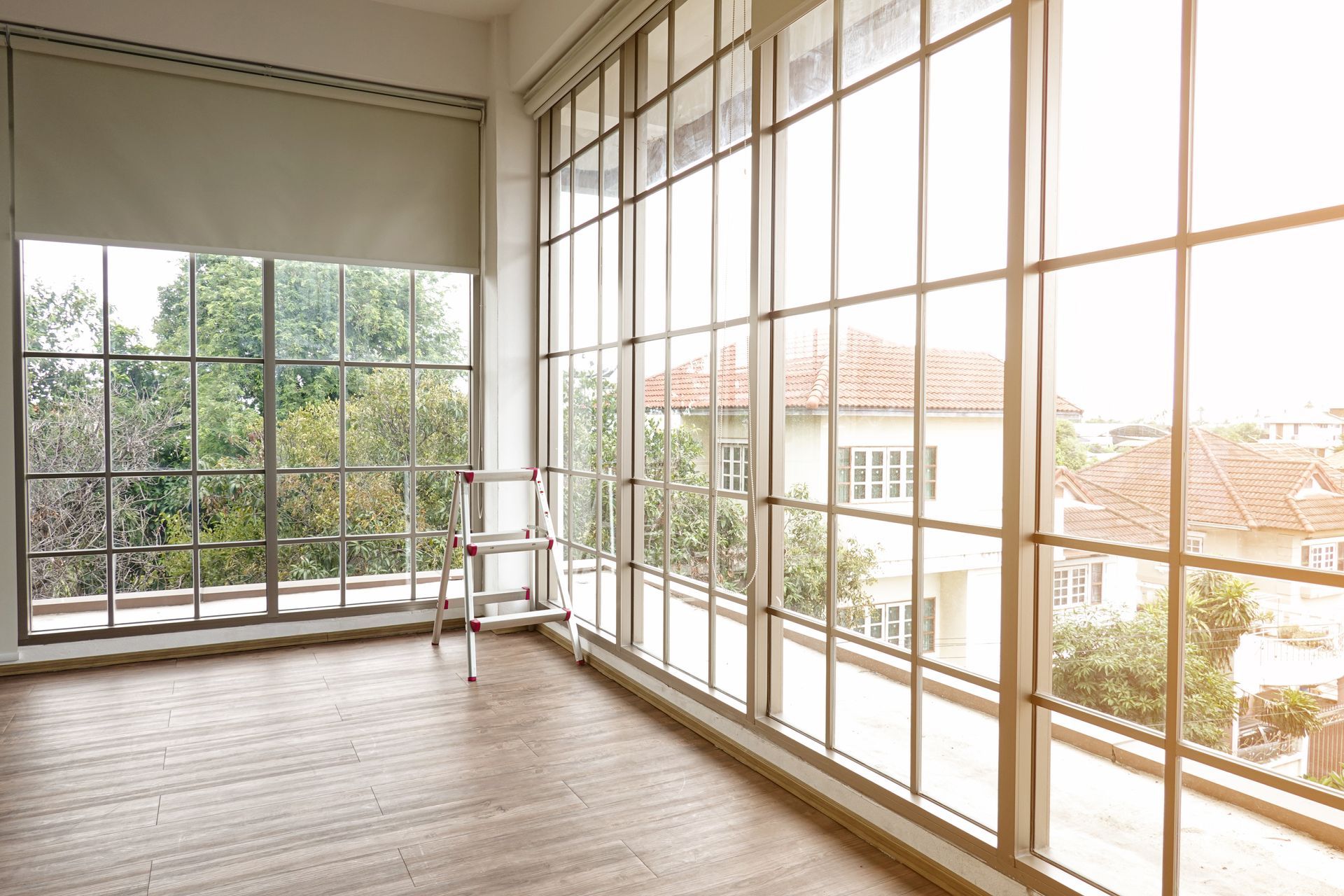 An empty room with a lot of windows and a chair.