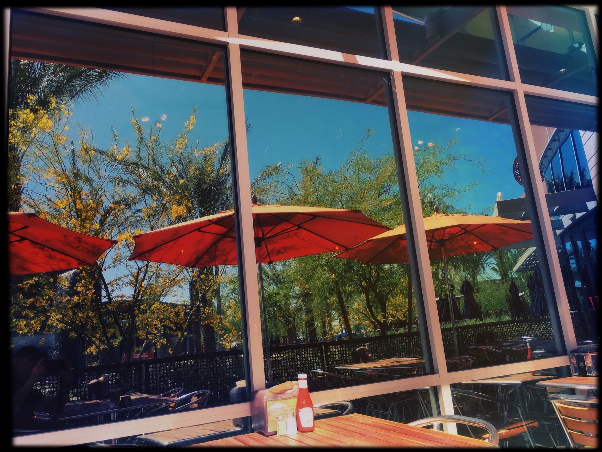 Umbrellas are reflected in the windows of a restaurant