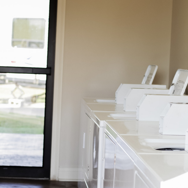 A row of washers and dryers in a laundromat