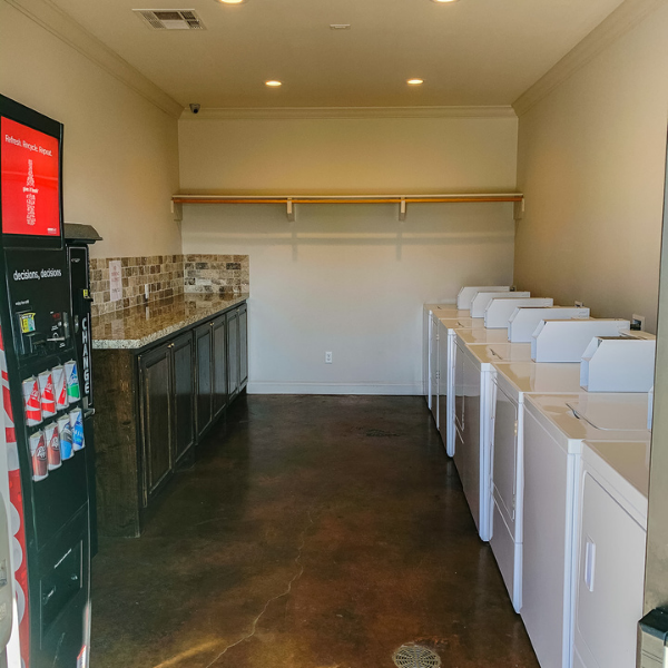A laundromat with a vending machine that says coca cola