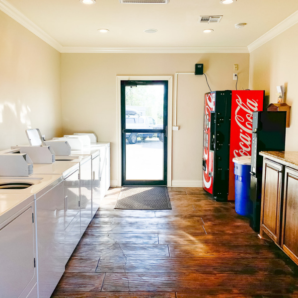 A laundromat with a coca cola vending machine