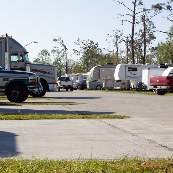 A row of rvs are parked on the side of the road