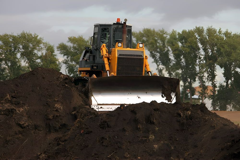 A Bulldozer Is Driving Through A Pile Of Dirt — Jeff Thompson Excavator Hire Pty Ltd In Pink Lily, QLD