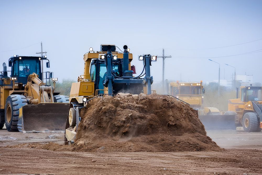 A Bulldozer Is Moving A Pile Of Dirt On A Construction Site — Jeff Thompson Excavator Hire Pty Ltd In Pink Lily, QLD
