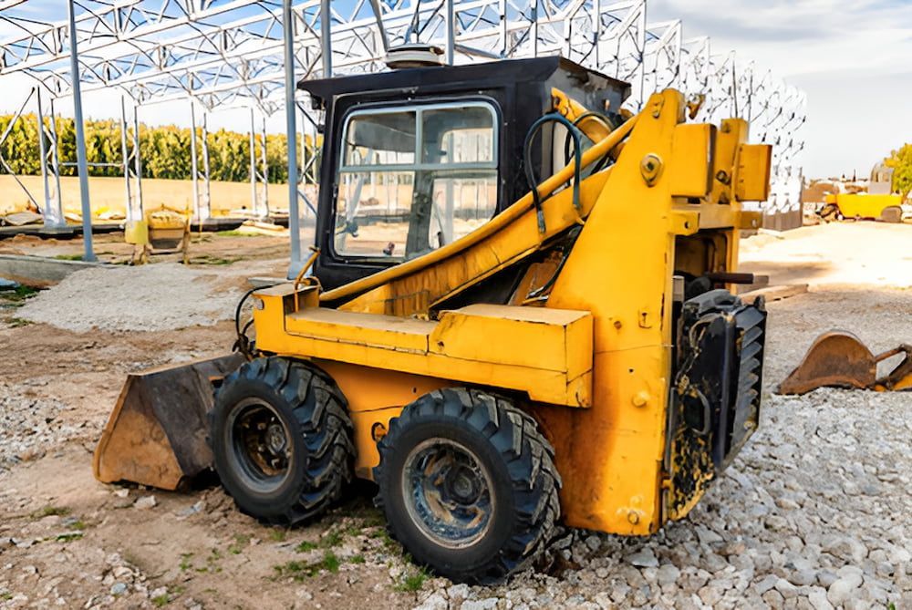 A Small Yellow Bulldozer Is Parked In A Gravel Lot — Jeff Thompson Excavator Hire Pty Ltd In Pink Lily, QLD