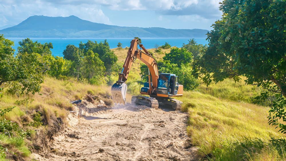 An Excavator Is Digging A Hole In The Dirt In A Field — Jeff Thompson Excavator Hire Pty Ltd In Pink Lily, QLD