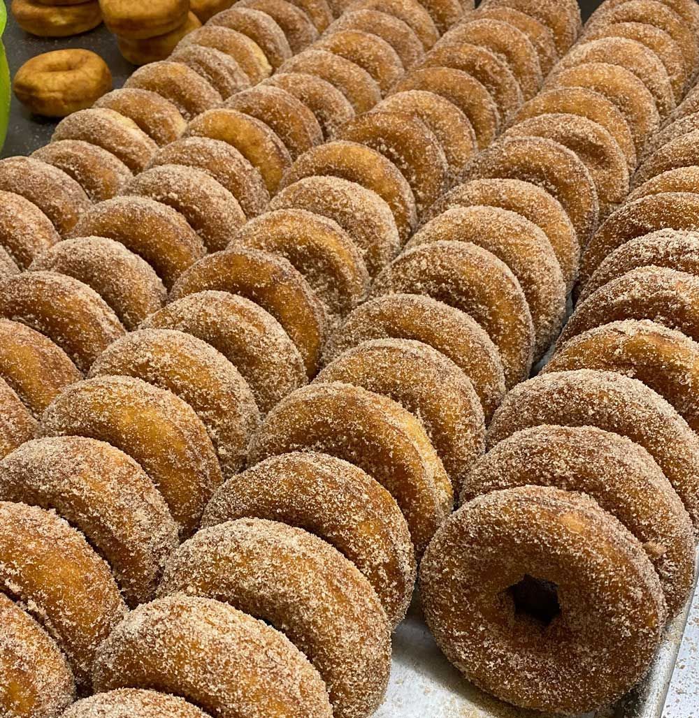 Rows of cinnamon sugar donuts.