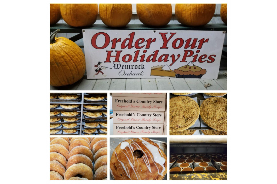 Sign promoting holiday pie orders from Wynn's Bakery. Pumpkin backdrop with baked goods, pies, and donuts.