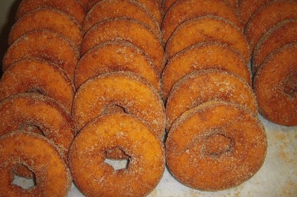 Pile of cinnamon sugar-coated donuts, stacked on top of each other.