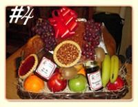 Fruit basket with grapes, pie, oranges, apples, bananas, and a red bow.