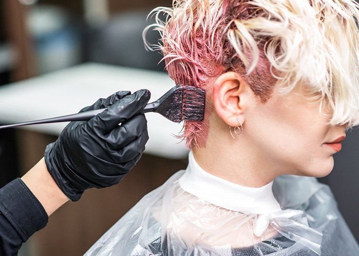 Hairdresser Paints the Woman's Hair in a Pink Color — Framingham, MA — Phillip De Palma Salon