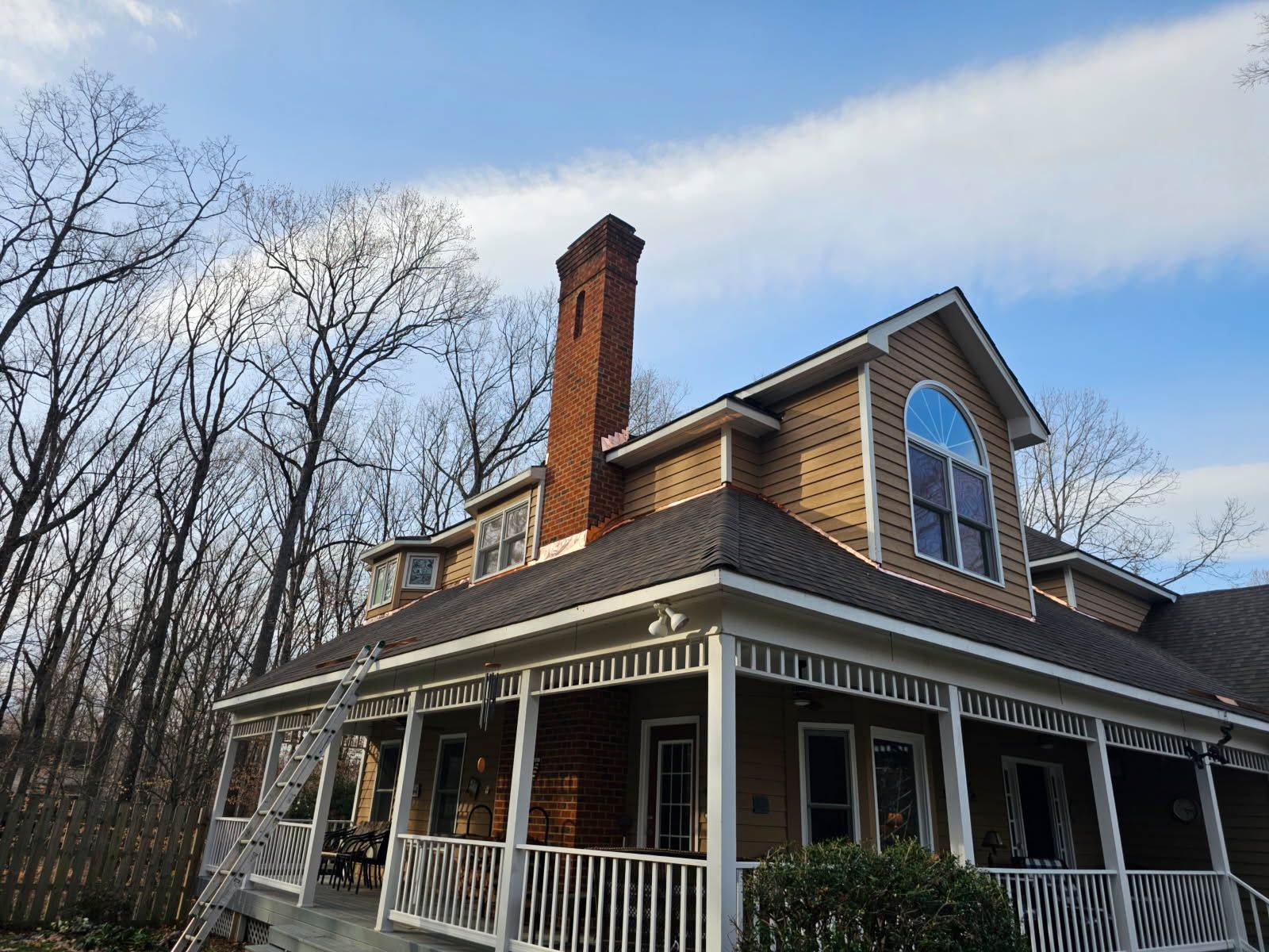 A group of men are installing solar panels on the roof of a house.