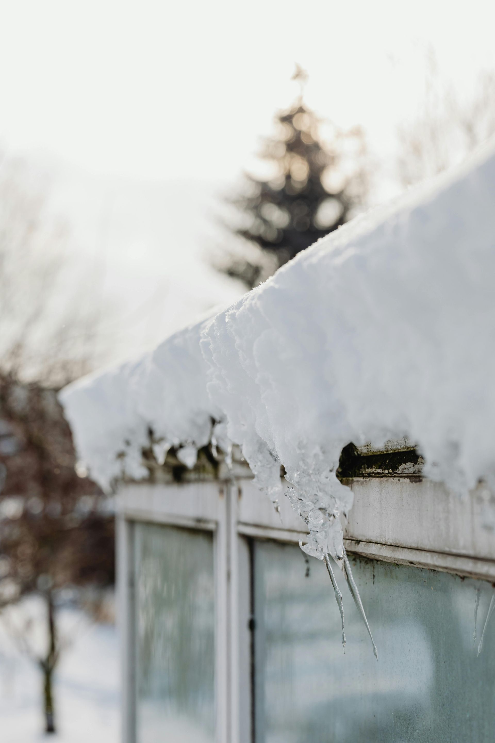 Winter storm roof damage with ice buildup on gutters in Richmond area home