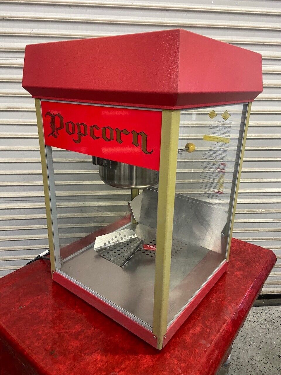 a close up of a popcorn machine filled with popcorn .