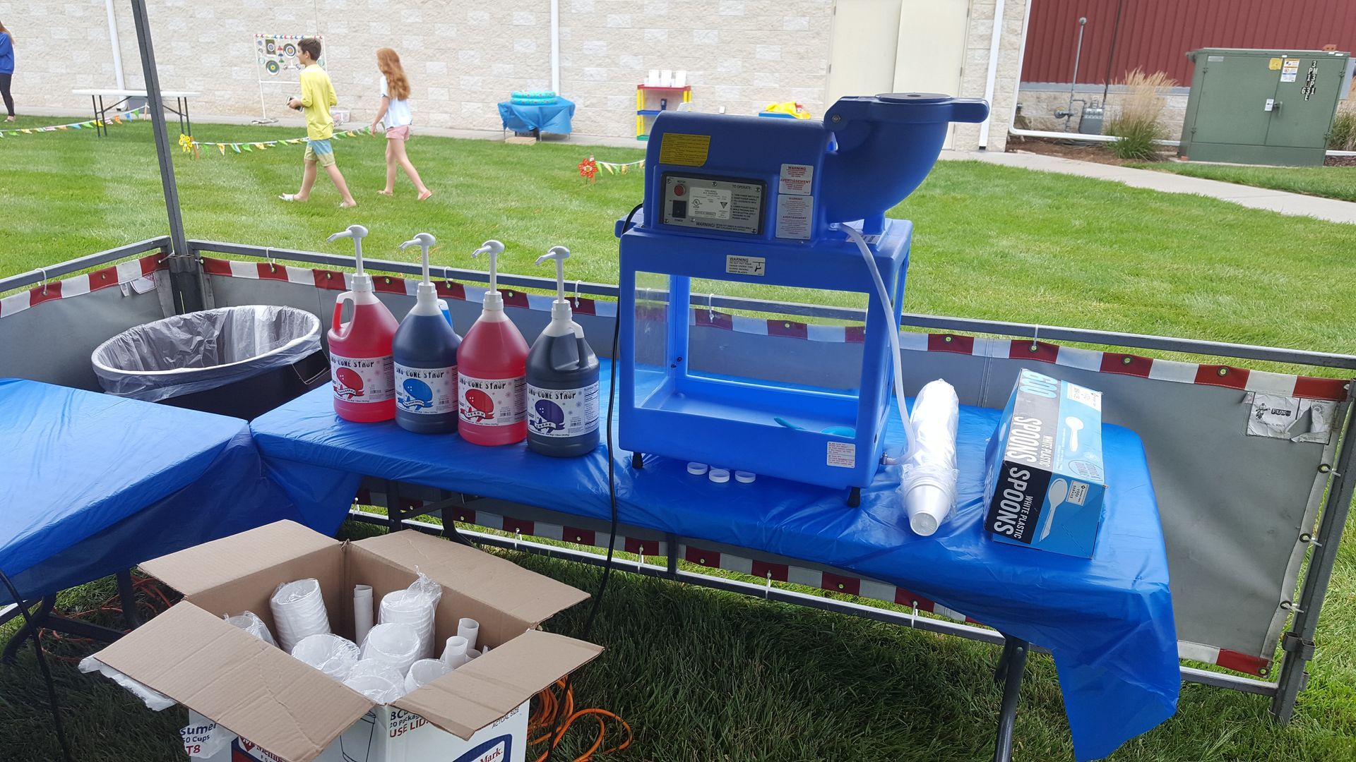 a person is holding a bowl of shaved ice with a spoon in it .
