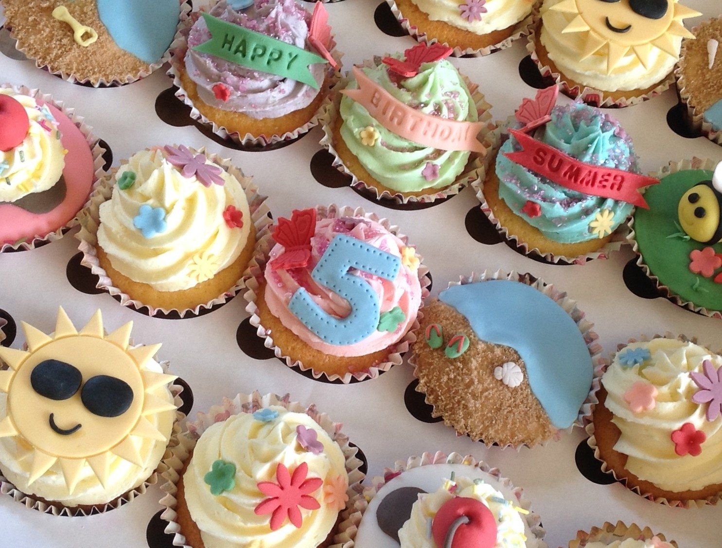 24 summer beach cupcakes with fondant decorationscreated by A Cherry On Top, Isle of Wight.