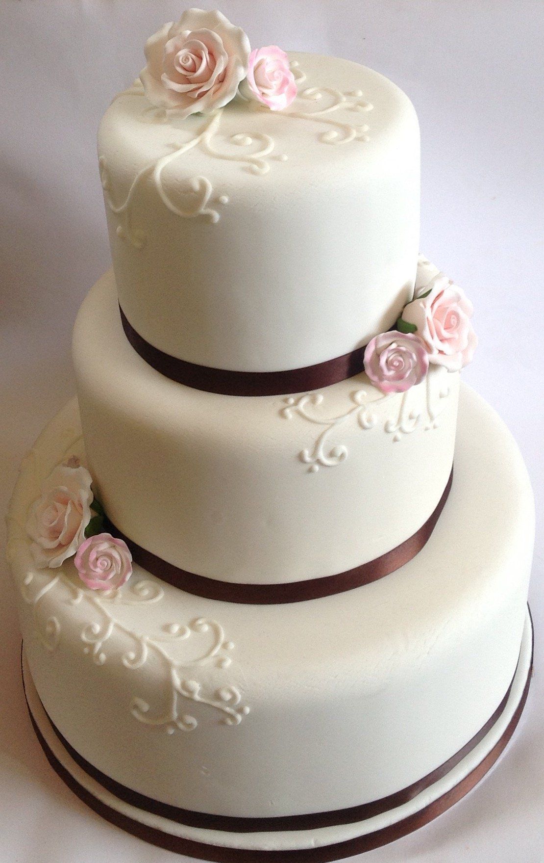 3 tiered ivory and brown wedding cake with pink roses created by A Cherry On Top, Isle of Wight.