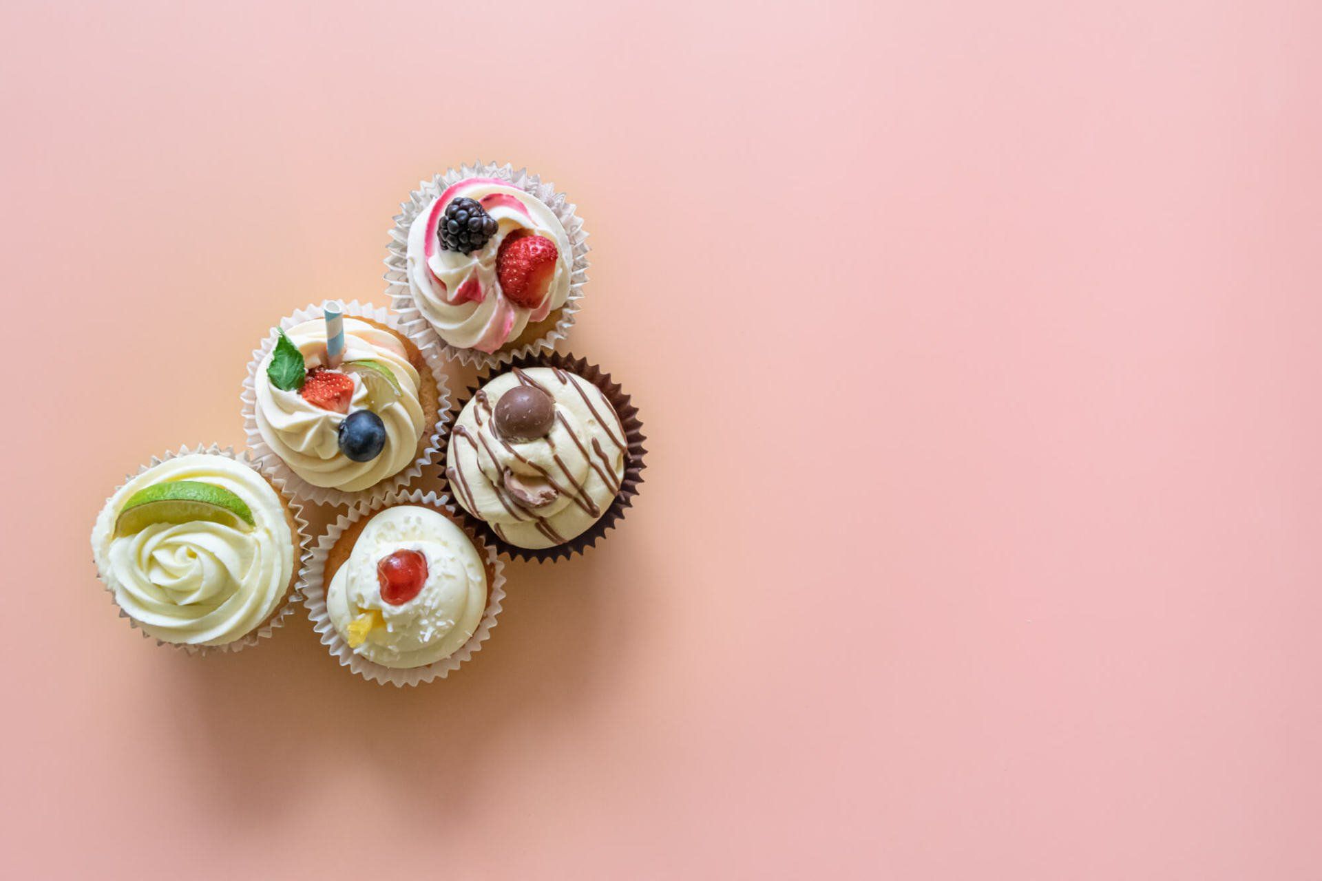 Birds eye view of five cupcakes with fluffy frosting created by A Cherry On Top, Isle of Wight. Photo by MooksGoo