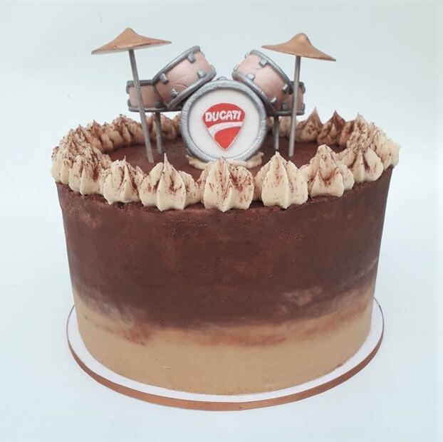 Buttercream cake with handmade fondant drum topper. Created by A Cherry On Top