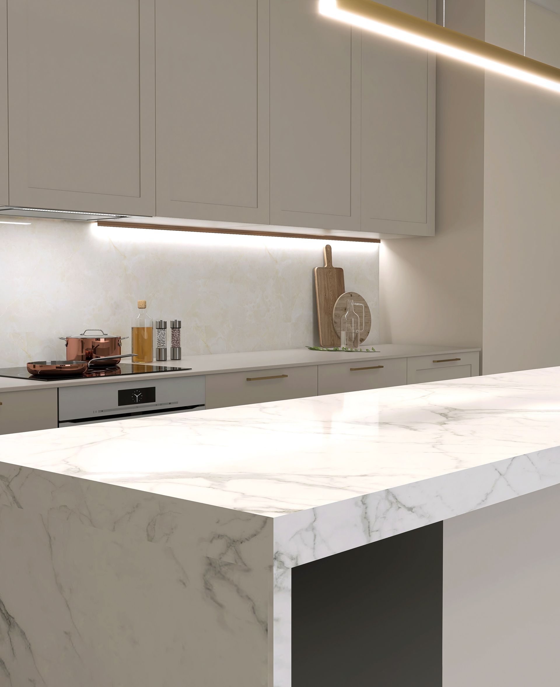 Modern kitchen with white marble countertop, light wood cabinets, and built-in lighting.