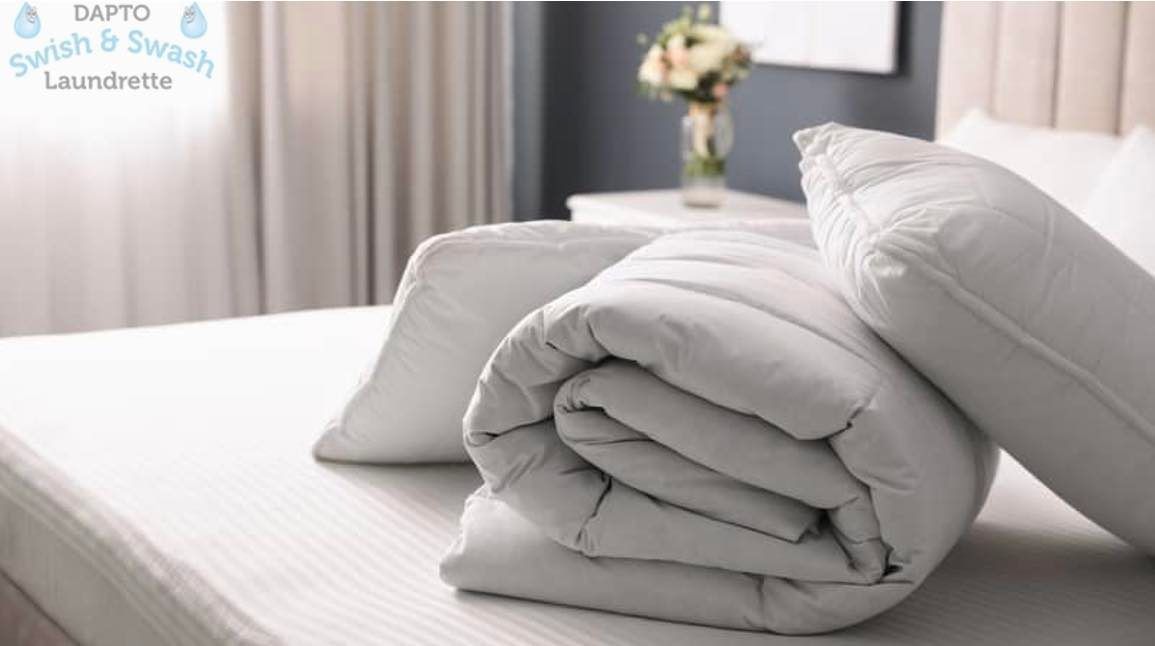 A Bed with A Comforter and Pillows — Dapto Swish & Swash Laundrette In Dapto, NSW