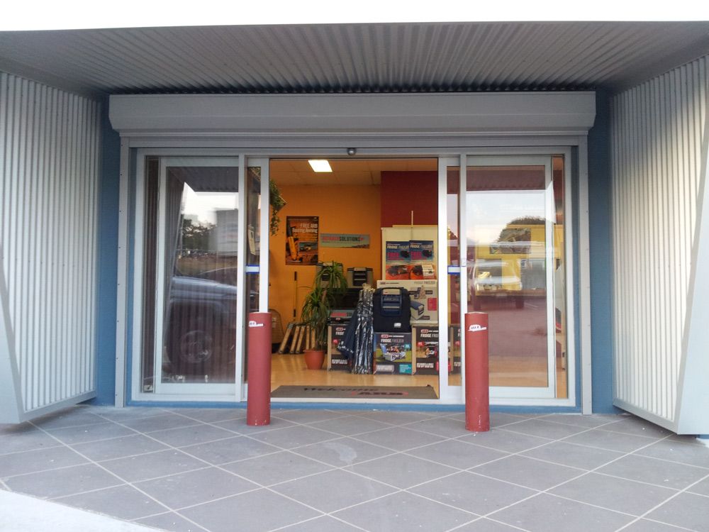 Commercial Building With Sliding Doors — Window Shutters in Wollongong, NSW