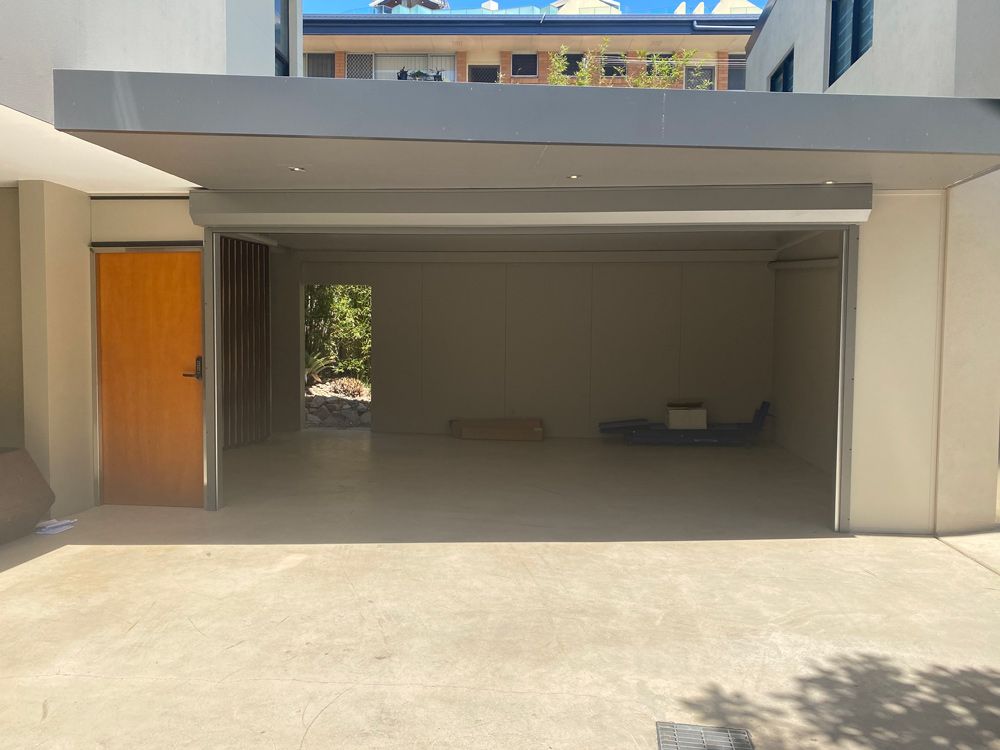 Open Garage Doors In Bramble Bay — Window Shutters in Wollongong, NSW