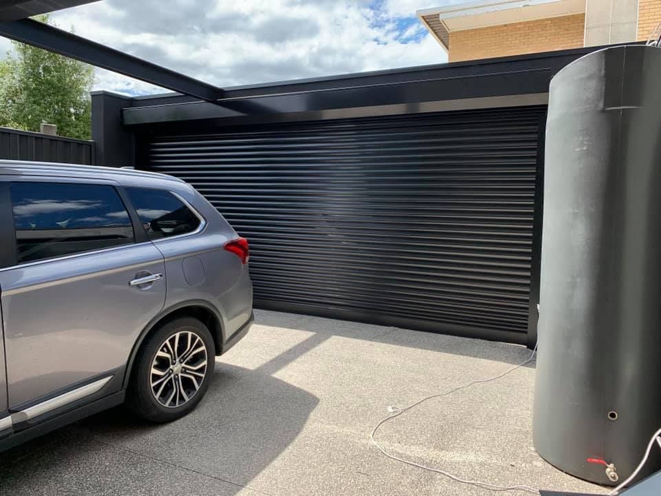 Grey Car Near Garage Door — Window Shutters in Wollongong, NSW