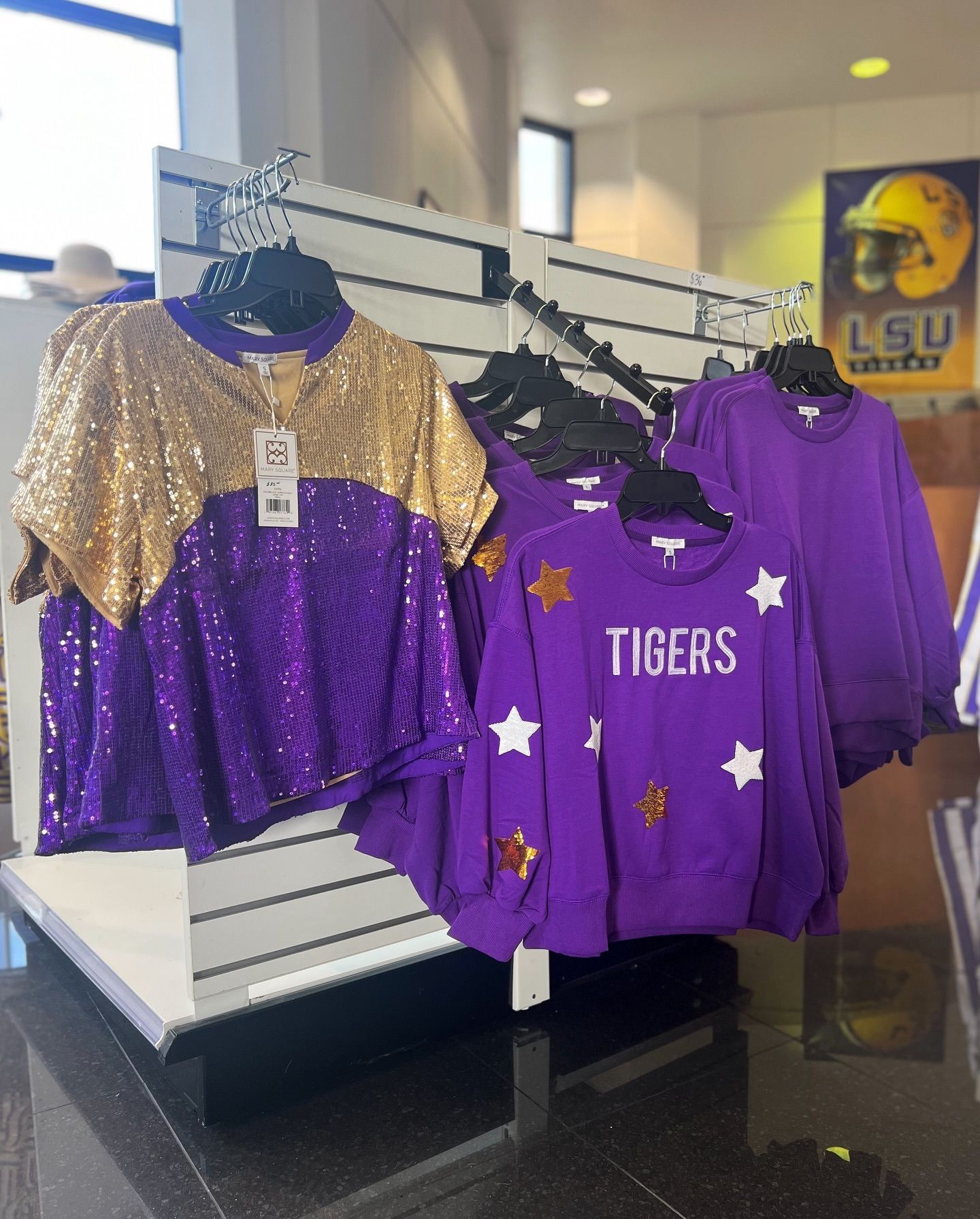 A display of purple and gold tigers shirts