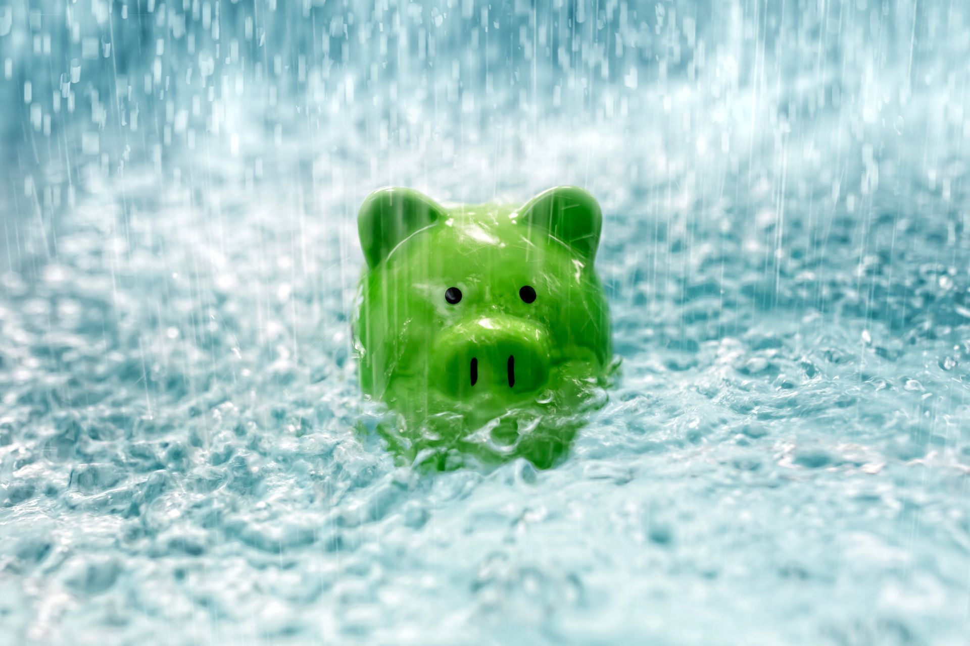 Green piggy bank splashing in water with foamy bubbles