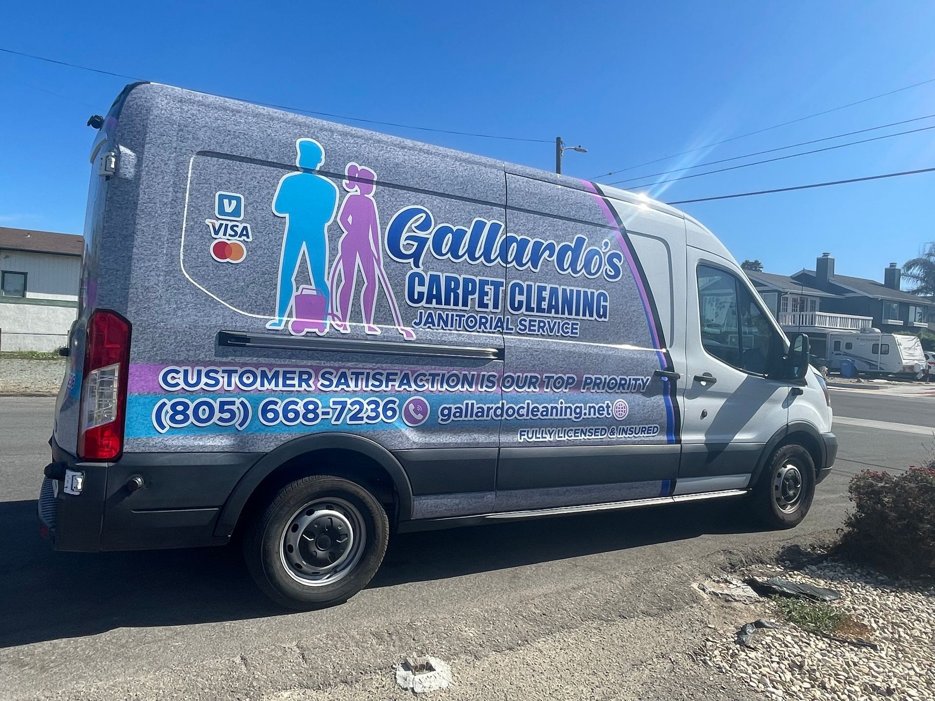 A carpet cleaning at home upholstery cleaning van is parked on the side of the road.