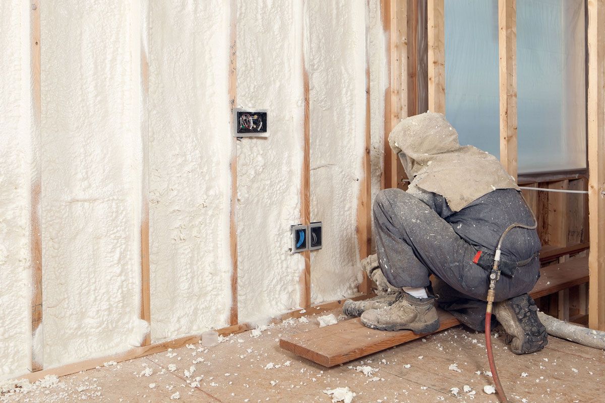 Man adding insulation to the wall
