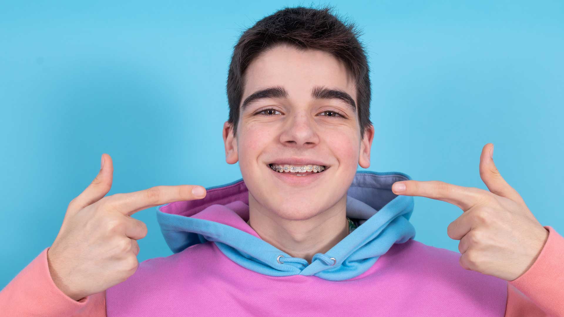 Happy teenage boy after Orthodontist adjusting braces