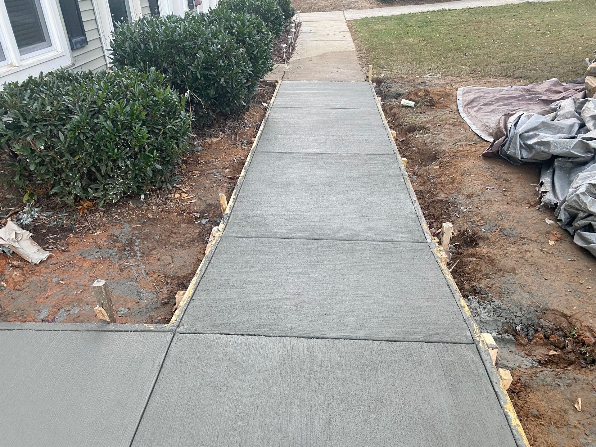 A yellow bulldozer is driving down a dirt road.
