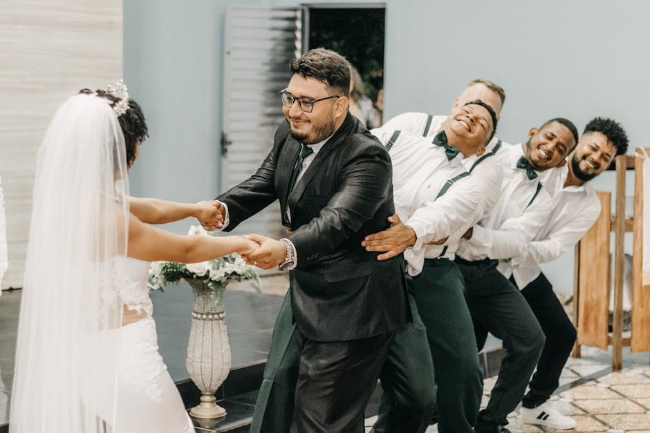 A bride and groom are dancing with their groomsmen.