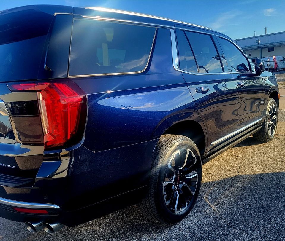 A blue suv is parked on the side of the road