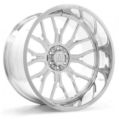 A close up of a chrome wheel on a white background.