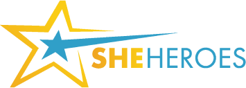 The logo for she heroes shows a star with a blue arrow coming out of it.