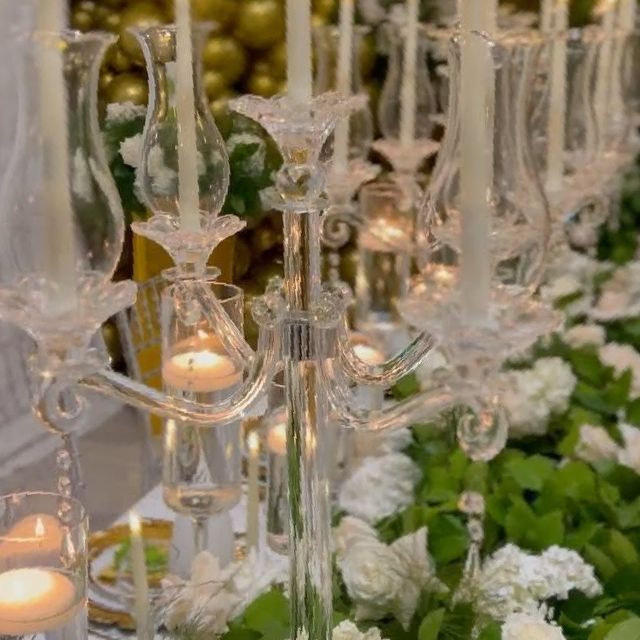 A long table with candles and flowers on it.