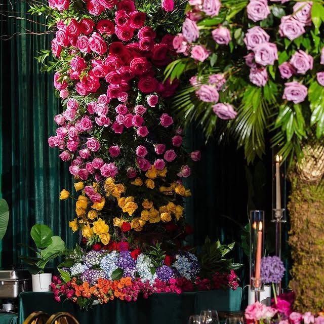 A bunch of flowers are hanging from a green curtain