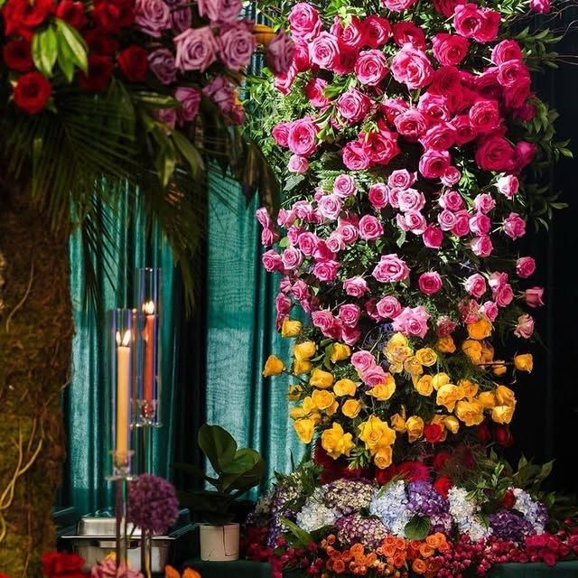 A bunch of flowers and candles on a table