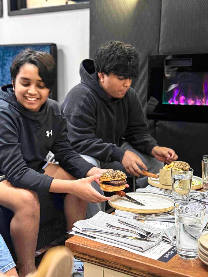 Friends enjoying burgers at The Social Pour Dallas