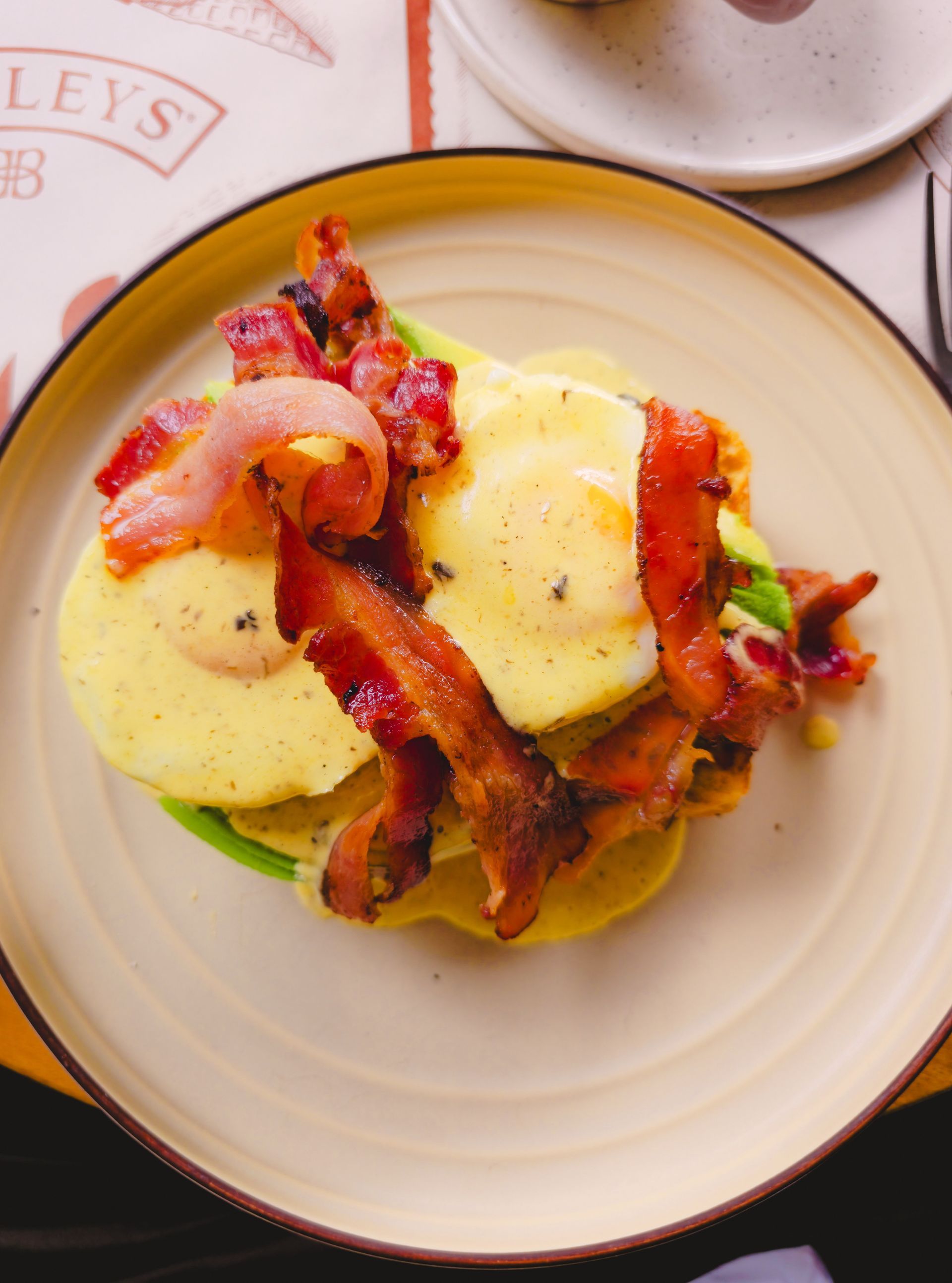 Bacon eggs Benedict with avocado.