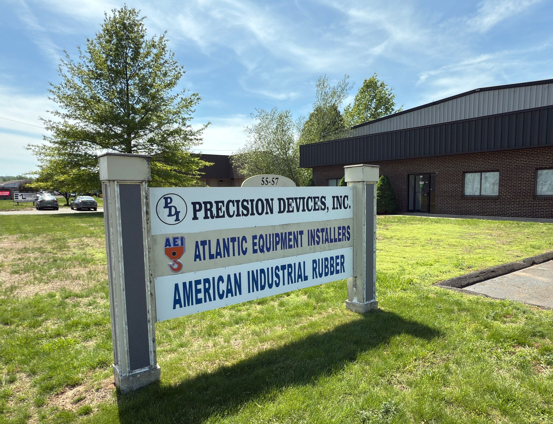 A sign in front of a building that says precision devices inc