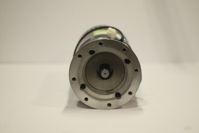 A close up of a motor on a white surface
