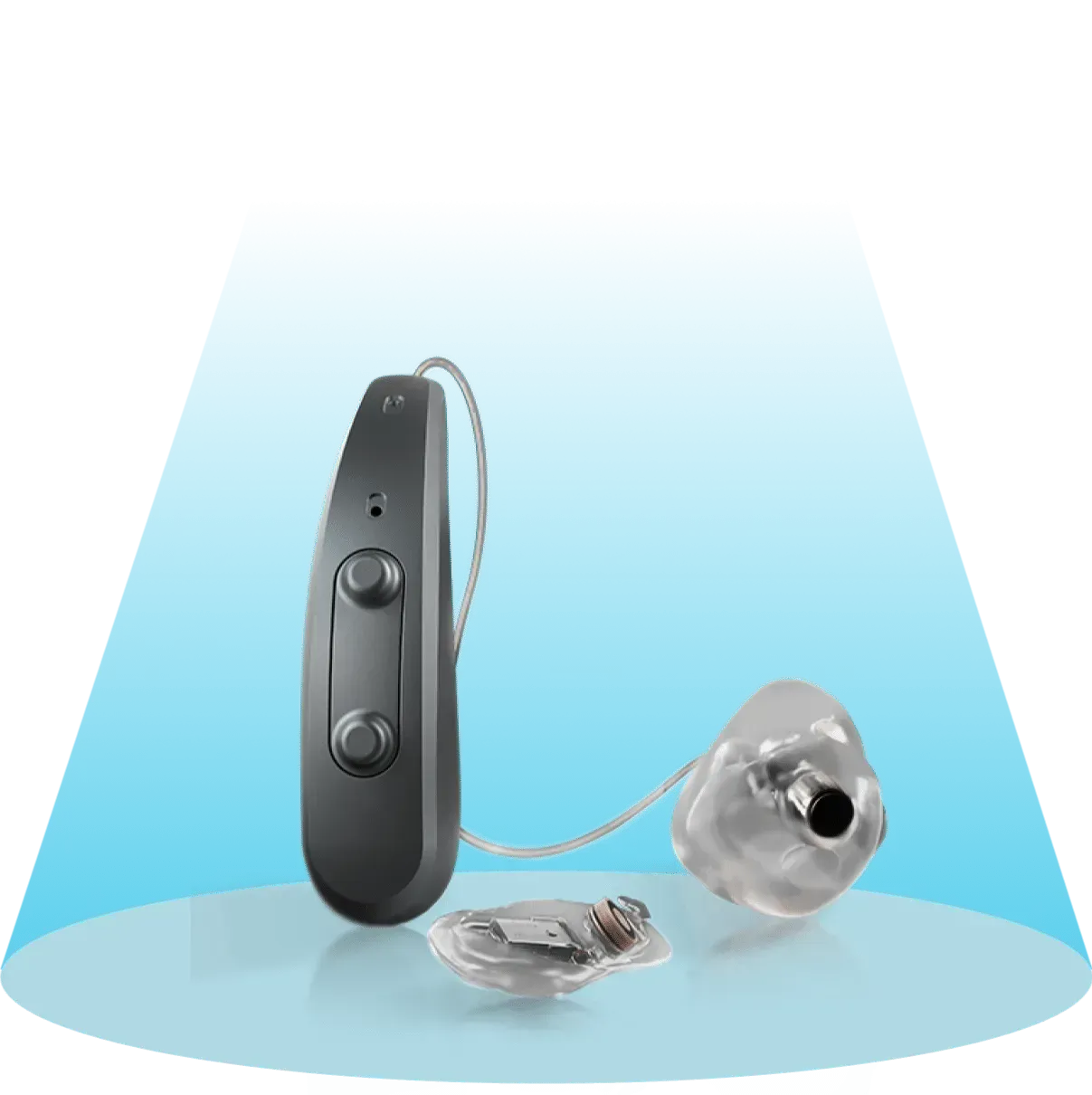 Gray hearing aid device with ear mold and battery, on a blue-lighted surface.