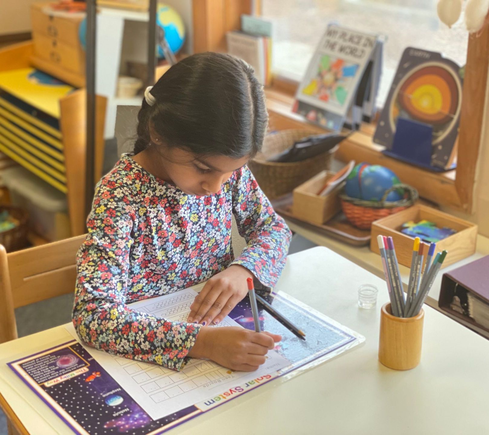 Montessori child working with cultural materials 