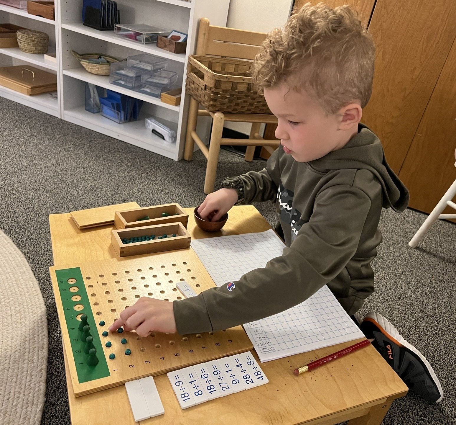 Child working with Montessori math materials