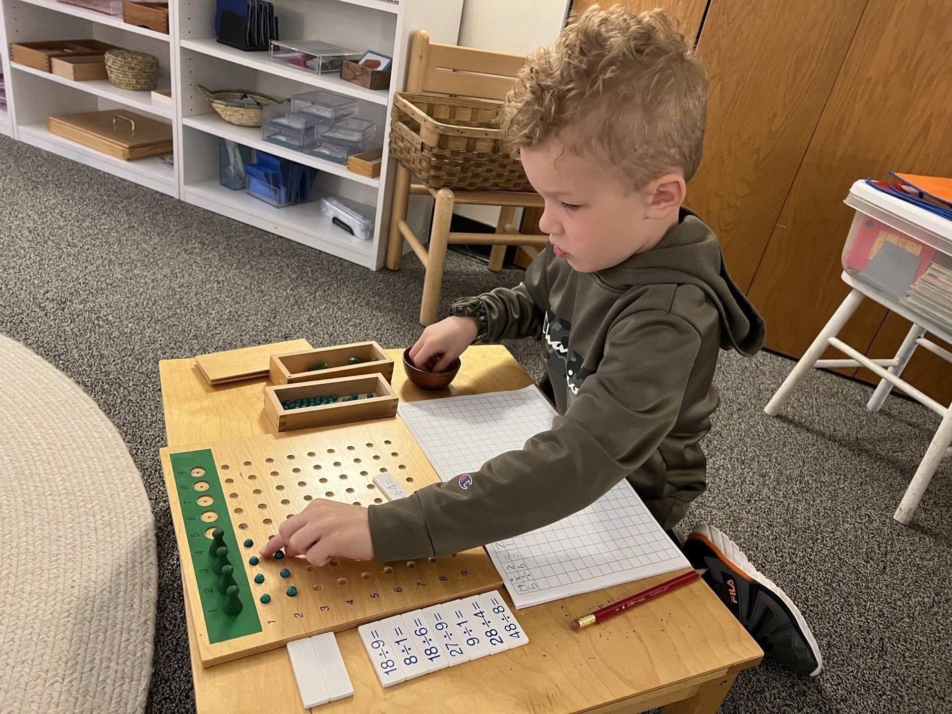 Child working with Montessori math materials