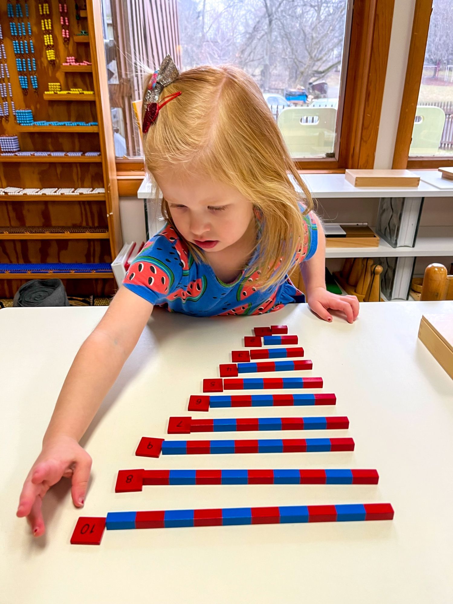 Child working with Montessori math materials